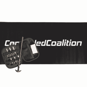 Universal gun cleaning kit with cleaning rod and zippered case on a black Concealed Coalition gun cleaning mat
