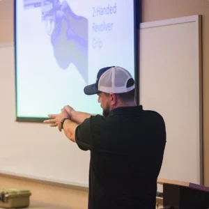 Concealed Coalition instructor demonstrating a two-handed revolver grip in a Colorado firearms safety class